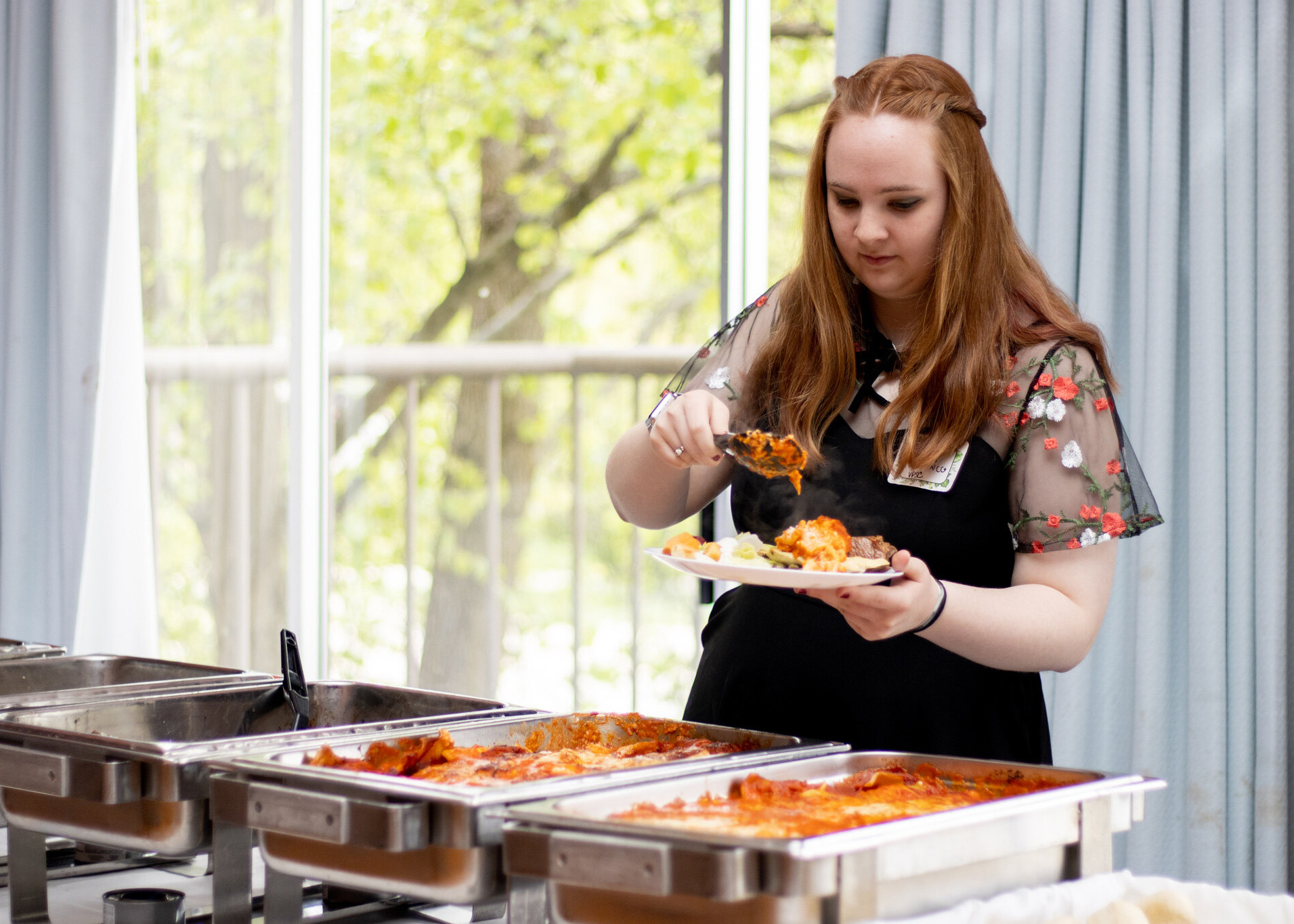 person getting food from catering line